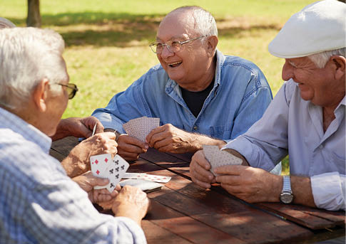 Four men are sitting around a table, playing cards. AI generated content