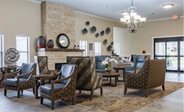 A large living room with a fireplace and a chandelier. The room has a couch, chairs, and a dining table. AI generated content